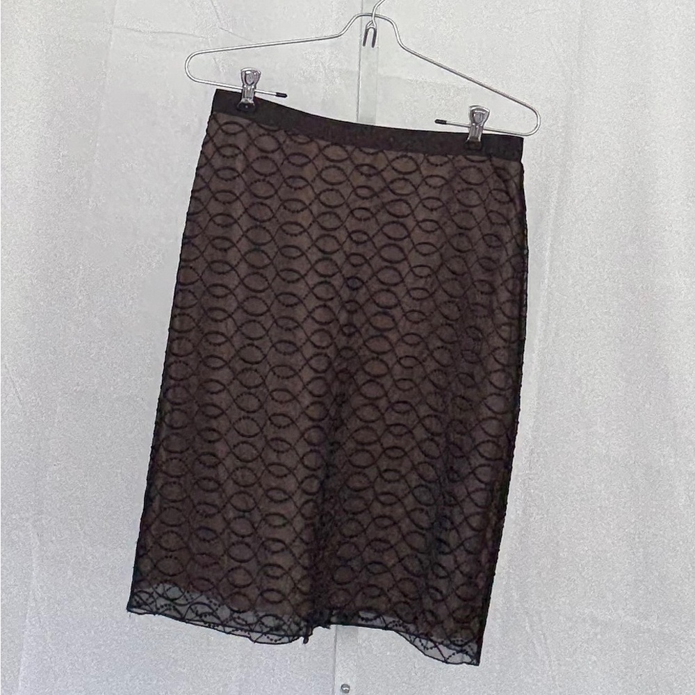 Kenar skirt. Black sheer top over nude lining.